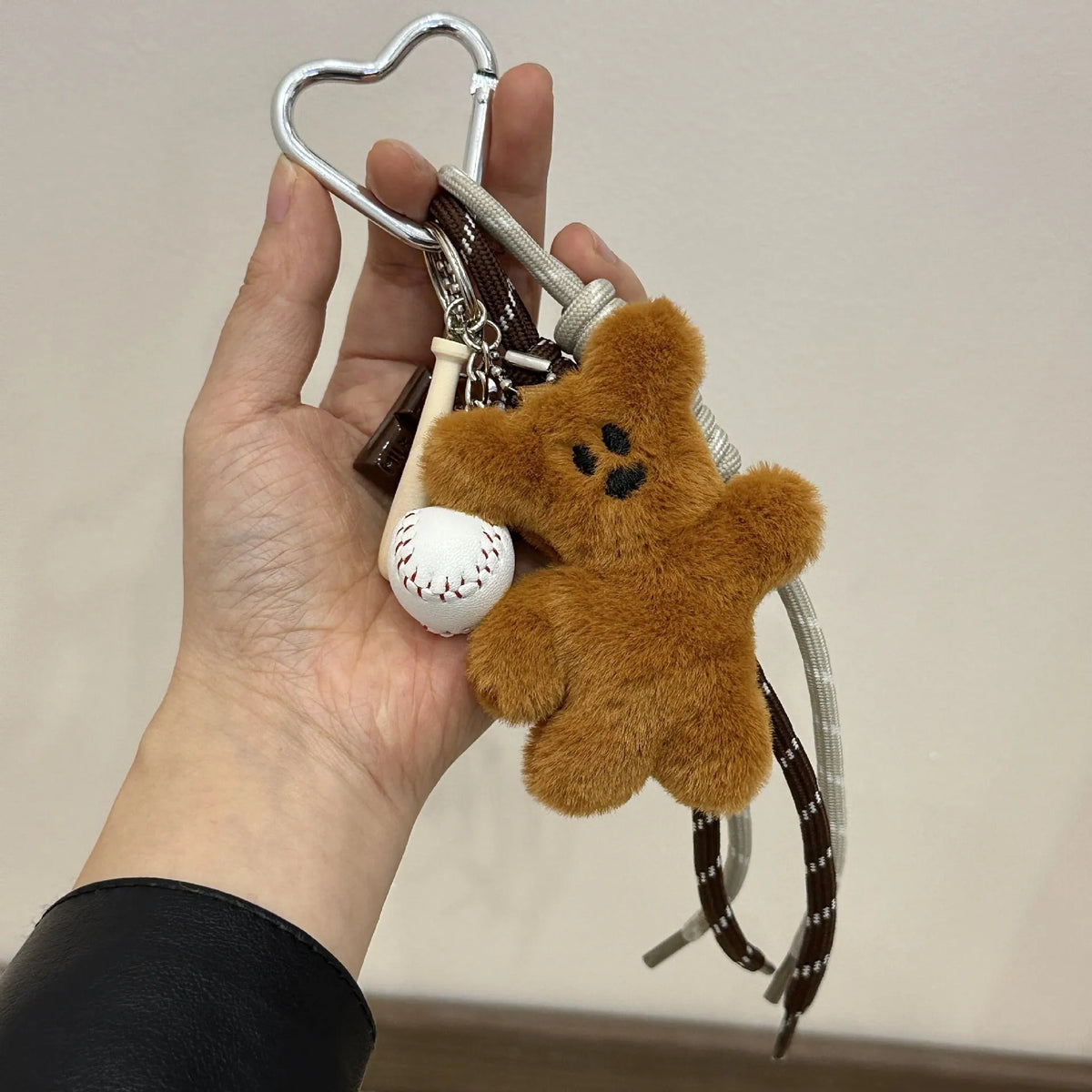 Soft plush brown bear doll pendant keychain hanging on a bag, with a cute bear/piglet animal pattern