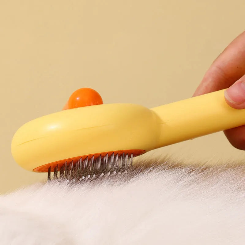 Small yellow duck-shaped pet grooming comb with open section design and needle teeth for cat and dog fur removal
