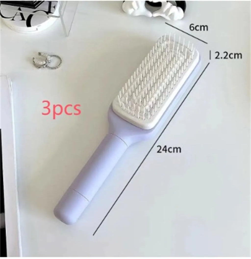 Purple self-cleaning hair brush with twist handle and massage comb teeth showing cleaning mechanism