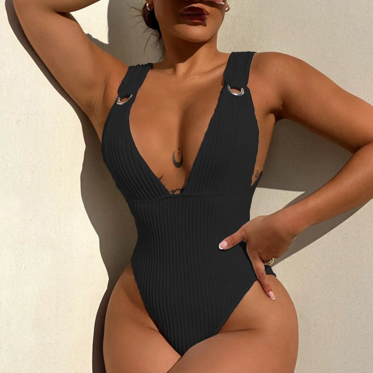 Solid colour one-piece swimsuit for women in black, white, green, or orange.