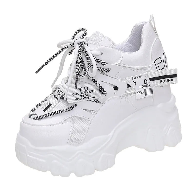 White women's low-top platform sports shoes with cross-strap and round toe on a rubber sole.
