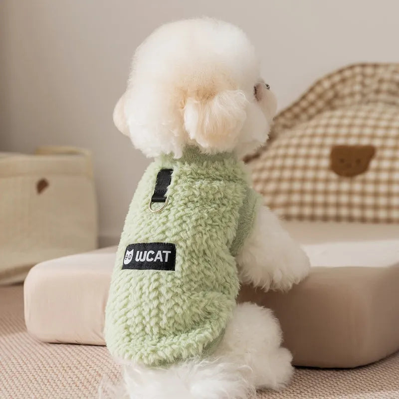 Two-legged sleeveless fleece dog vest with integrated leash ring in soft green or neutral beige, sizes XS to XL