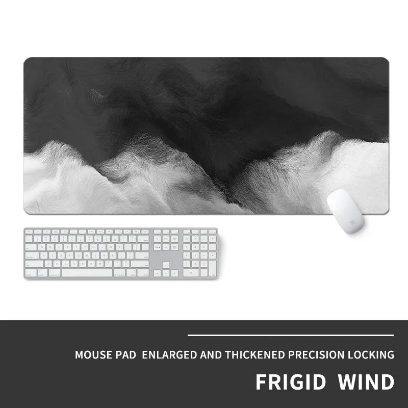 Large grey gaming mouse pad with geometric cool-style design on desk with keyboard and mouse.