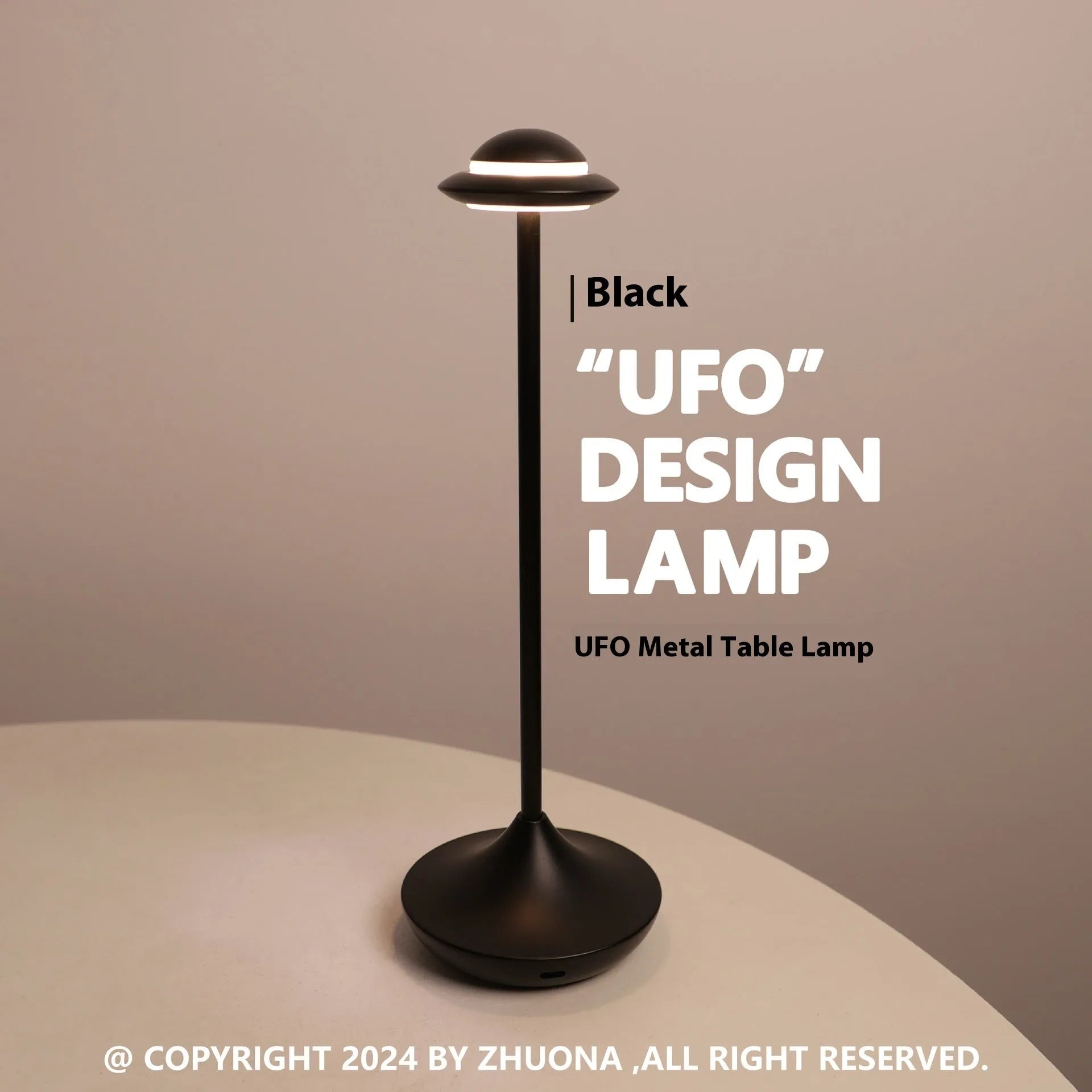 Rechargeable UFO-shaped metal desk lamp in black on a wooden table.