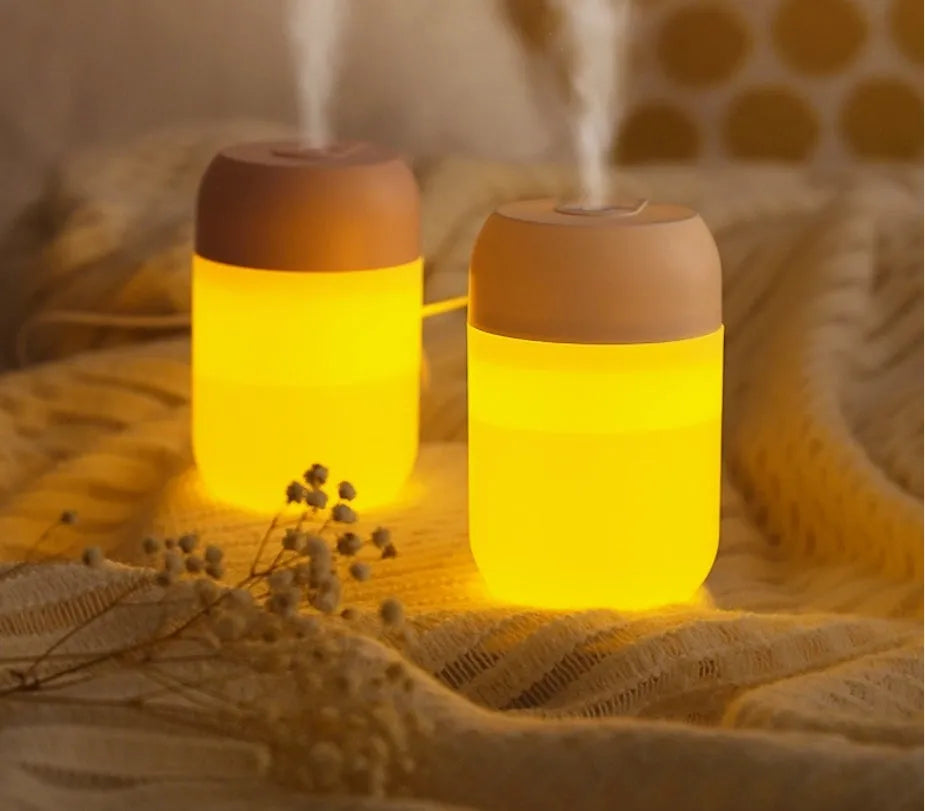 Small white cylindrical USB-powered humidifier for silent bedroom and desk use.