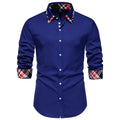 Men's blue plaid long sleeve shirt with a black triangle contrast collar.