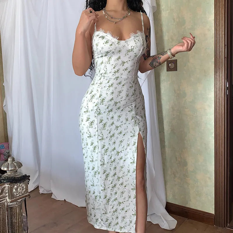 Women's blue lace flowers print long dress with suspender straps and a side slit on a model.