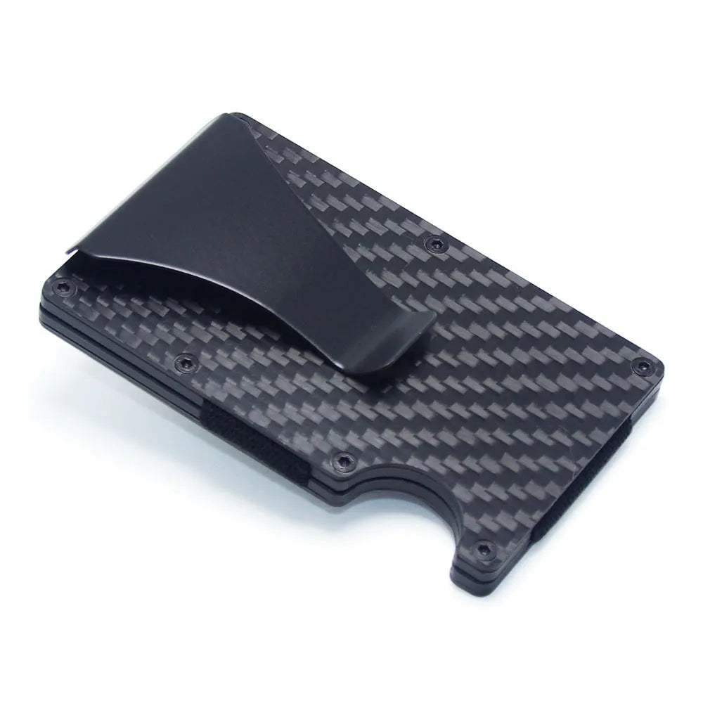 Slim black carbon fibre card holder wallet with geometric design on a desk.