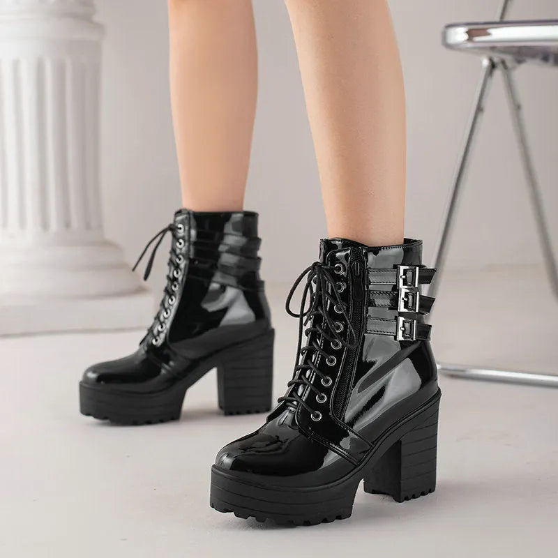 Women's black thick-heel ankle boots with lace-up front and round toe on a rubber sole.