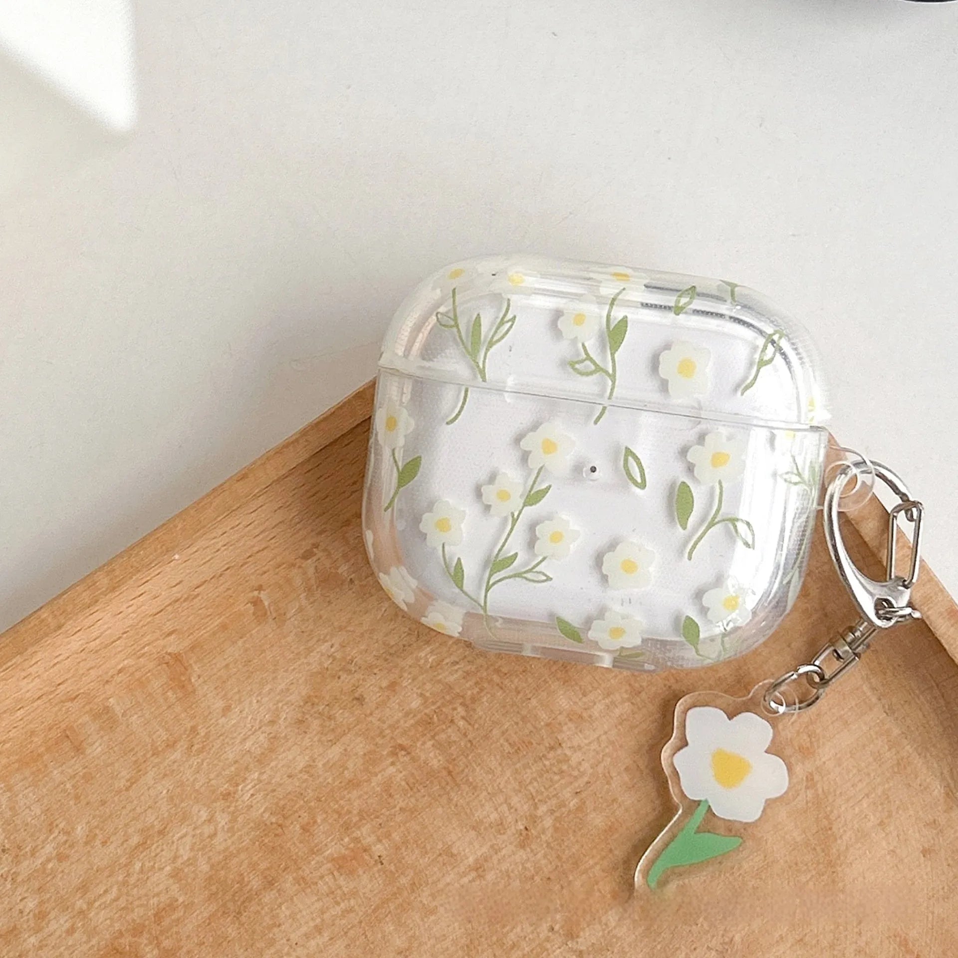 White floral pattern transparent TPU soft cover for Apple AirPods charging case.