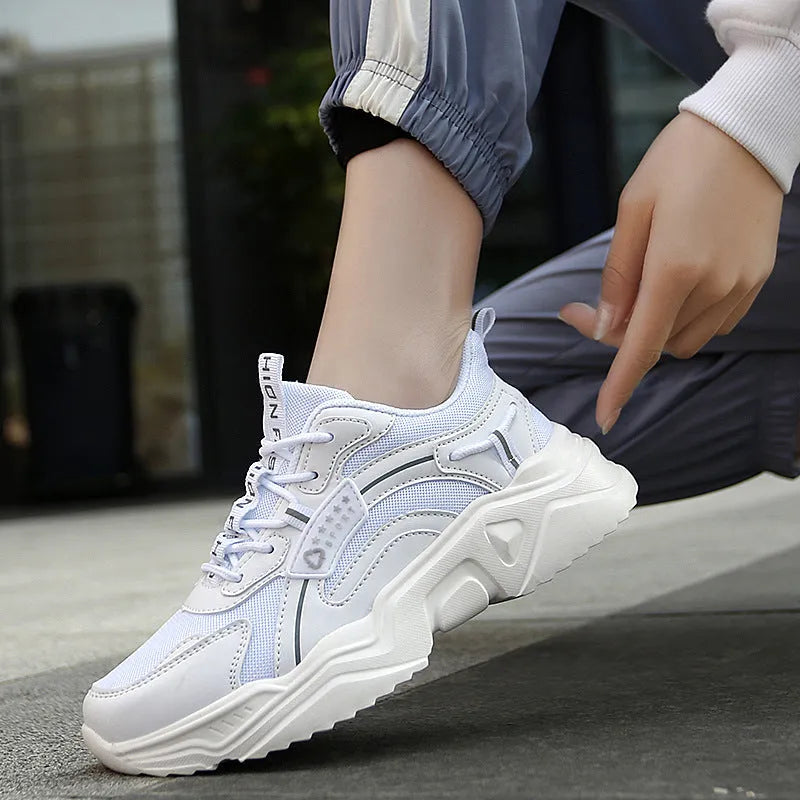 White women's casual sports shoes with mesh upper, thick PU sole, round toe, and a buckle strap.