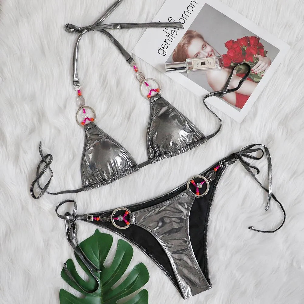 Silver women's bikini swimsuit with split design and briefs style on mannequin