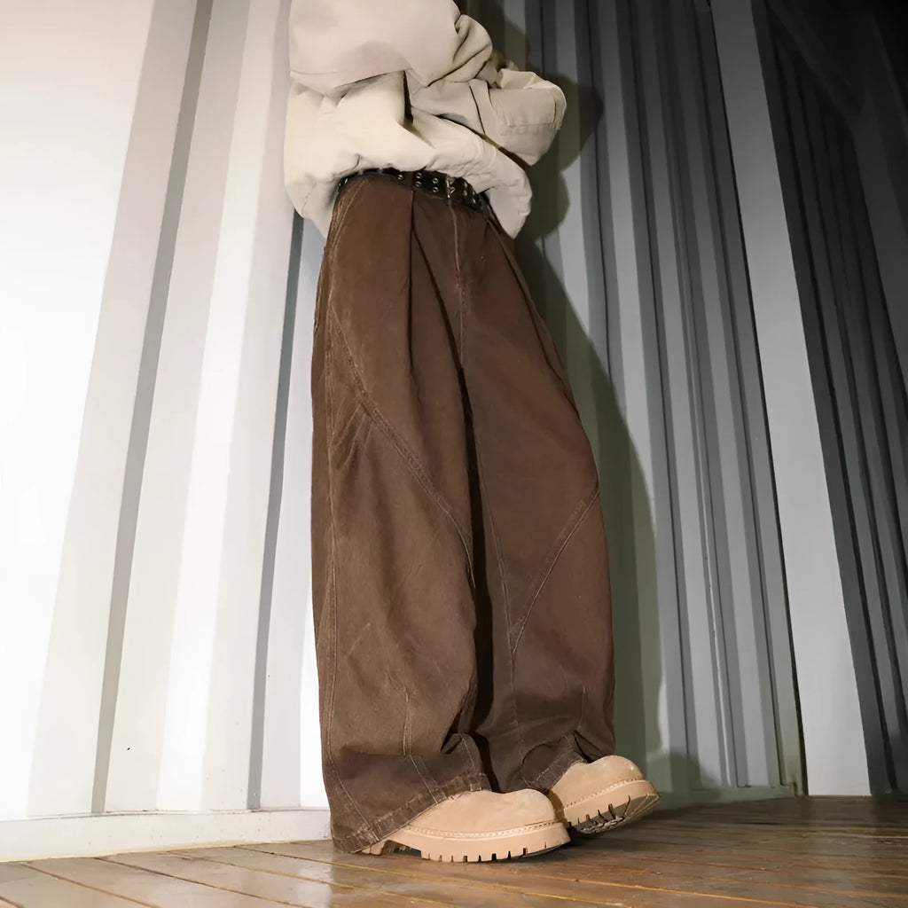 Men's pleated straight-leg trousers in a striped pattern, showing loose fit and straight hem.