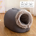 Grey fleece-lined enclosed cat sleeping bag bed for pets in a cage.