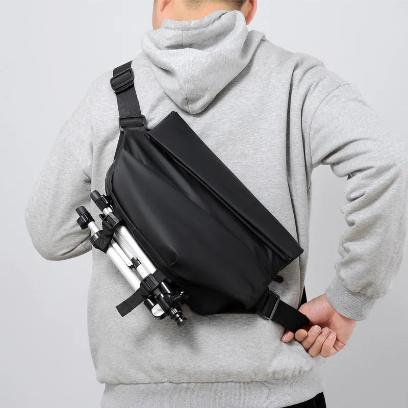 A medium-sized grey crossbody bag for men made from PU leather with a single shoulder strap.