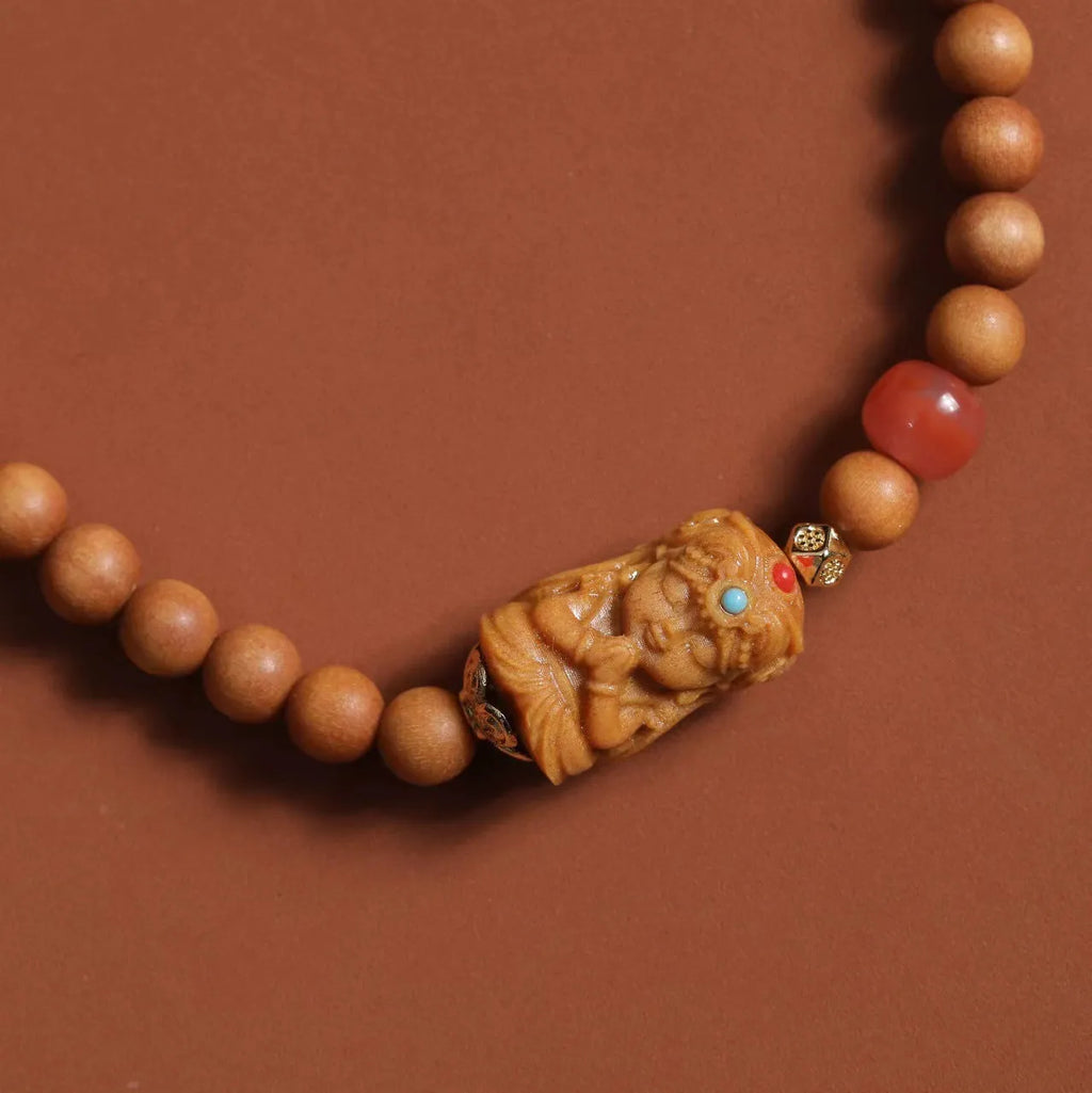 Brown wooden bracelet with 6mm round beads featuring a woven South Red Zachilam double circle design.