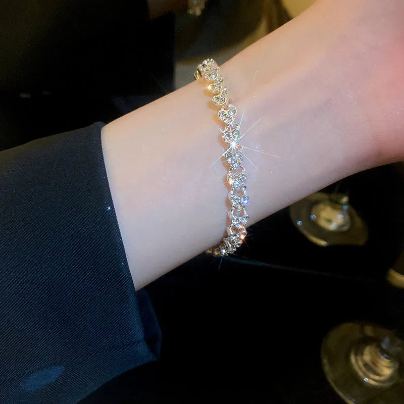 Silver heart shaped metal bracelet with inlaid zircon stones for women
