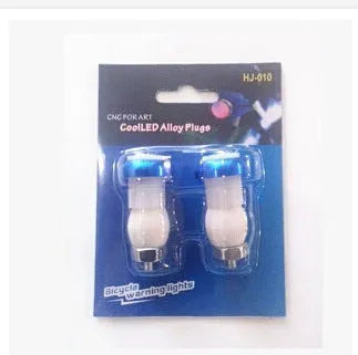 A pair of anodised aluminium bicycle handlebar end lights in a choice of colours, showing the red LED and white rubber switch.