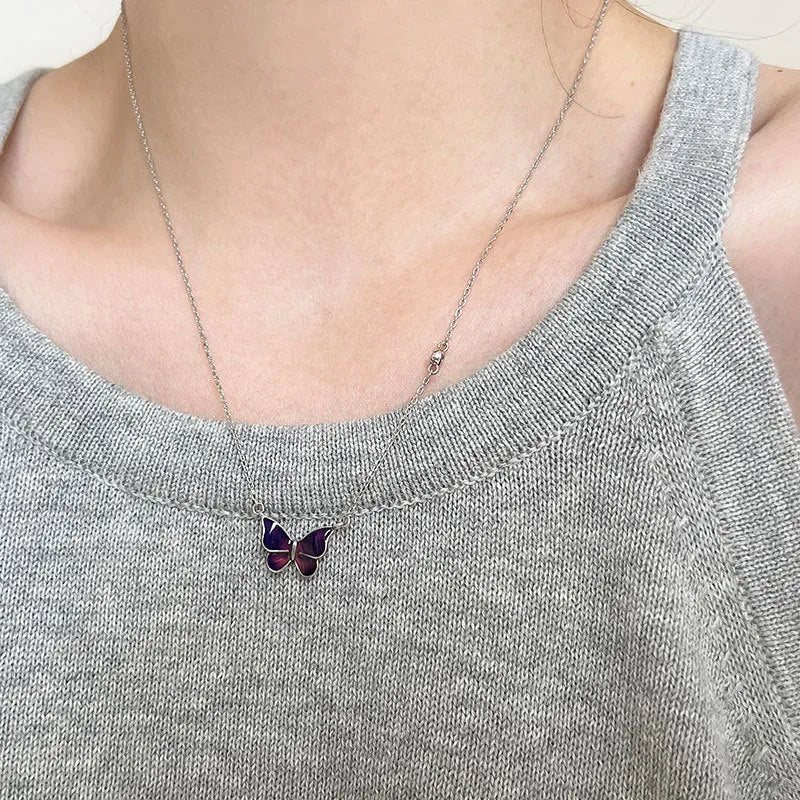 S925 silver butterfly necklace with white silver colour-change pendant on display