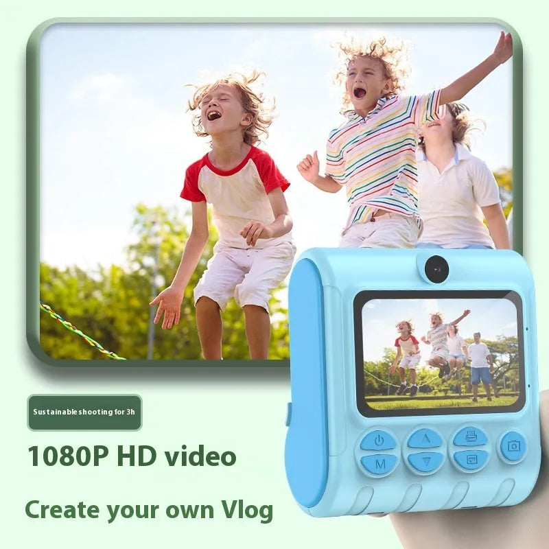 Children's instant thermal printing camera in pink with dual lenses, including lanyard and charging cable on white background
