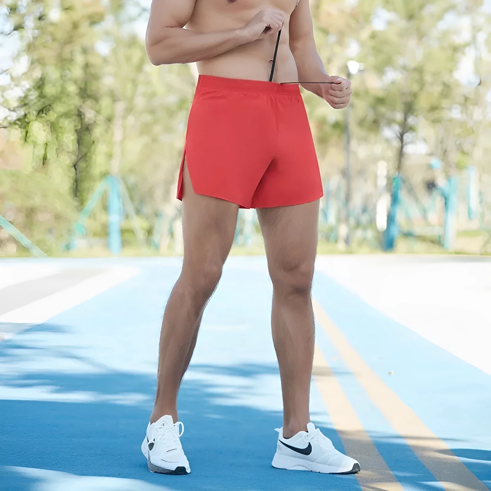 Man wearing high-waisted, loose-fit black off-road running shorts for marathon training.