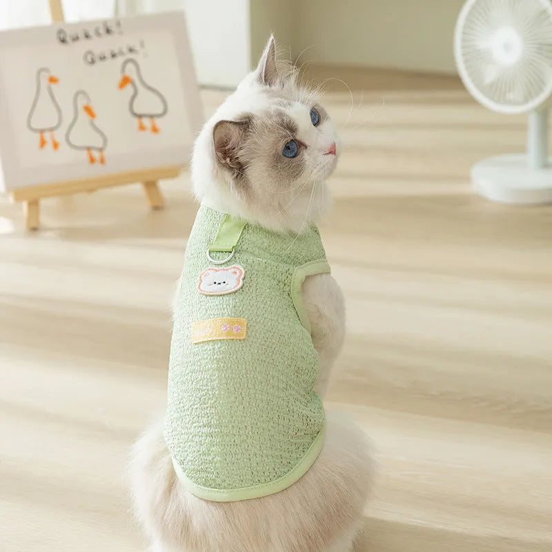 Green knitted cat clothes with a hollowed-out bear patch cartoon design.