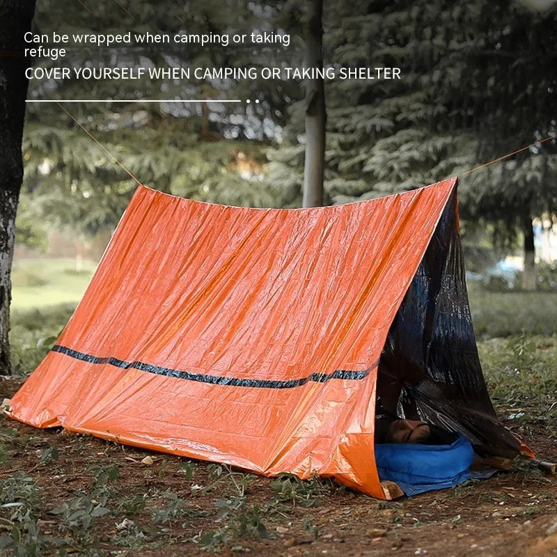 Orange and green emergency tents with sleeping bags and survival whistle for outdoor disaster relief