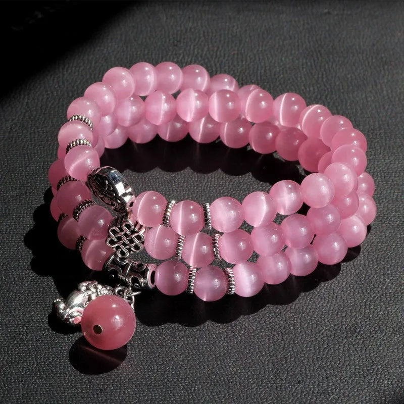 Women's adjustable opal bracelet with Lucky Cat charm and geometric beads in blue.
