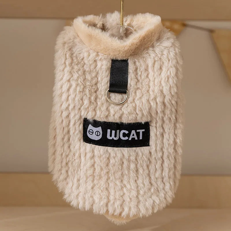 Two-legged sleeveless fleece dog vest with integrated leash ring in soft green or neutral beige, sizes XS to XL