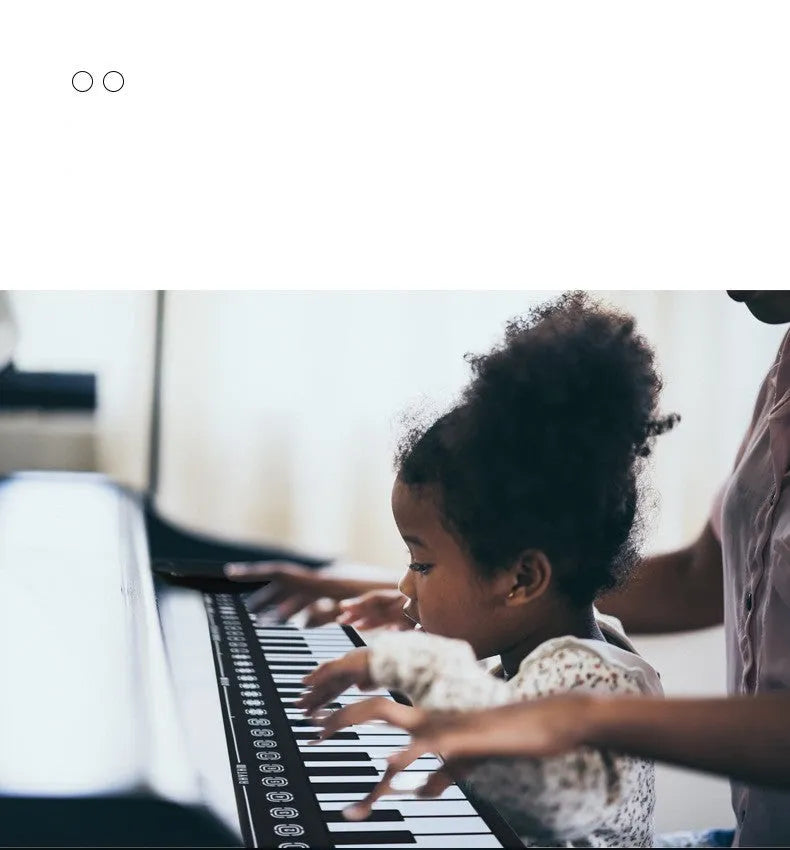 Pearl white portable folding electronic keyboard with 49 silicone keys and a built-in speaker, shown folded and unfolded.
