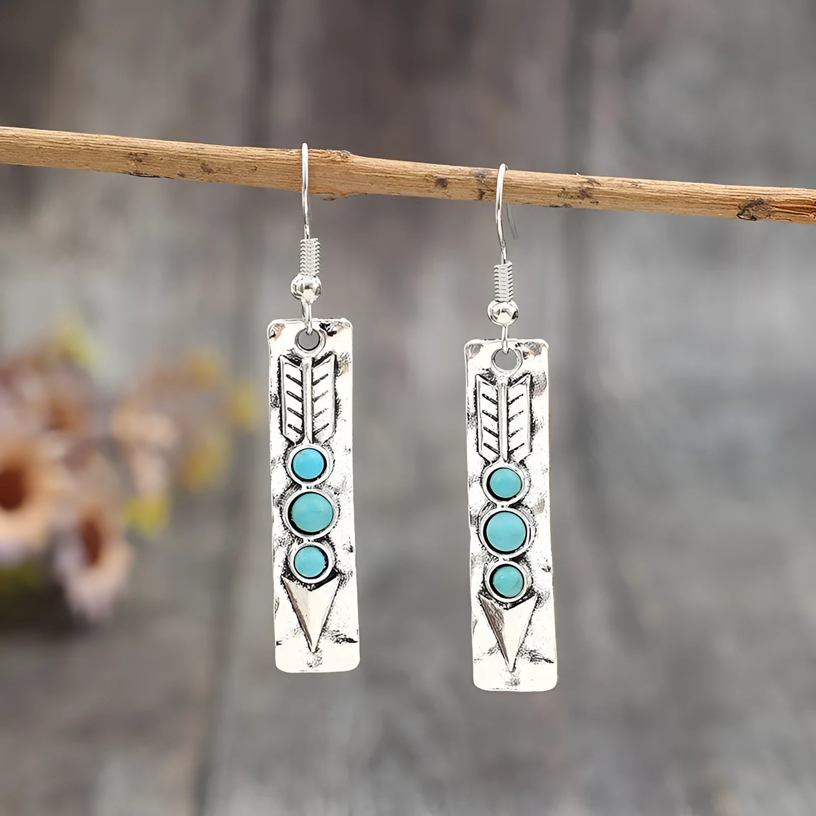 Silver geometric drop earrings with turquoise inlays and retro styling on white background