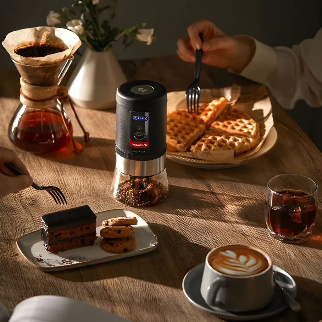 Black portable hand crank coffee grinder with manual grinding mechanism on counter