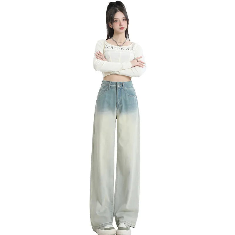 Gradient blue straight-leg women's jeans on a neutral background showing the colour transition.