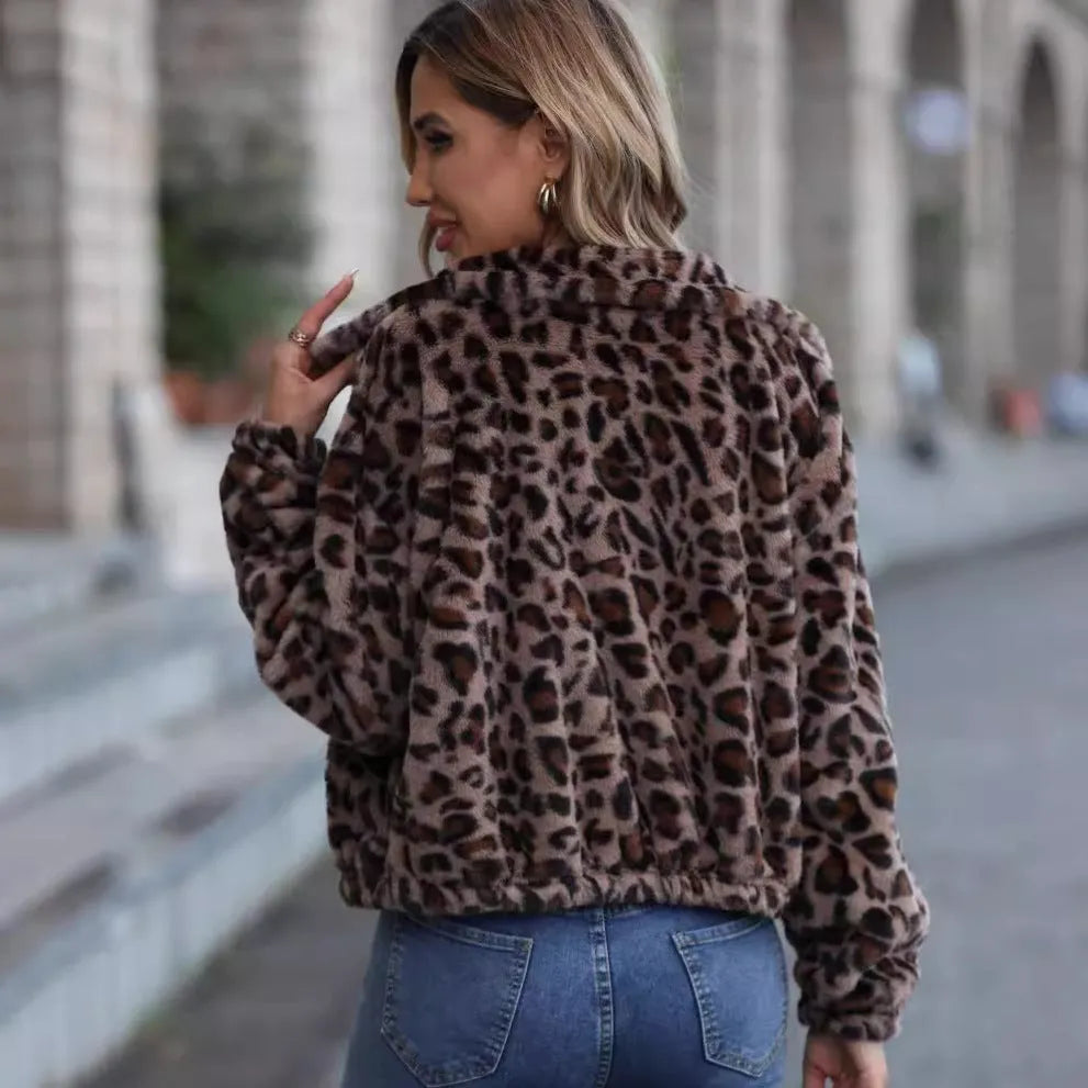 A woman's loose long-sleeve zip-up coat in a plush leopard print fabric with raglan sleeves.