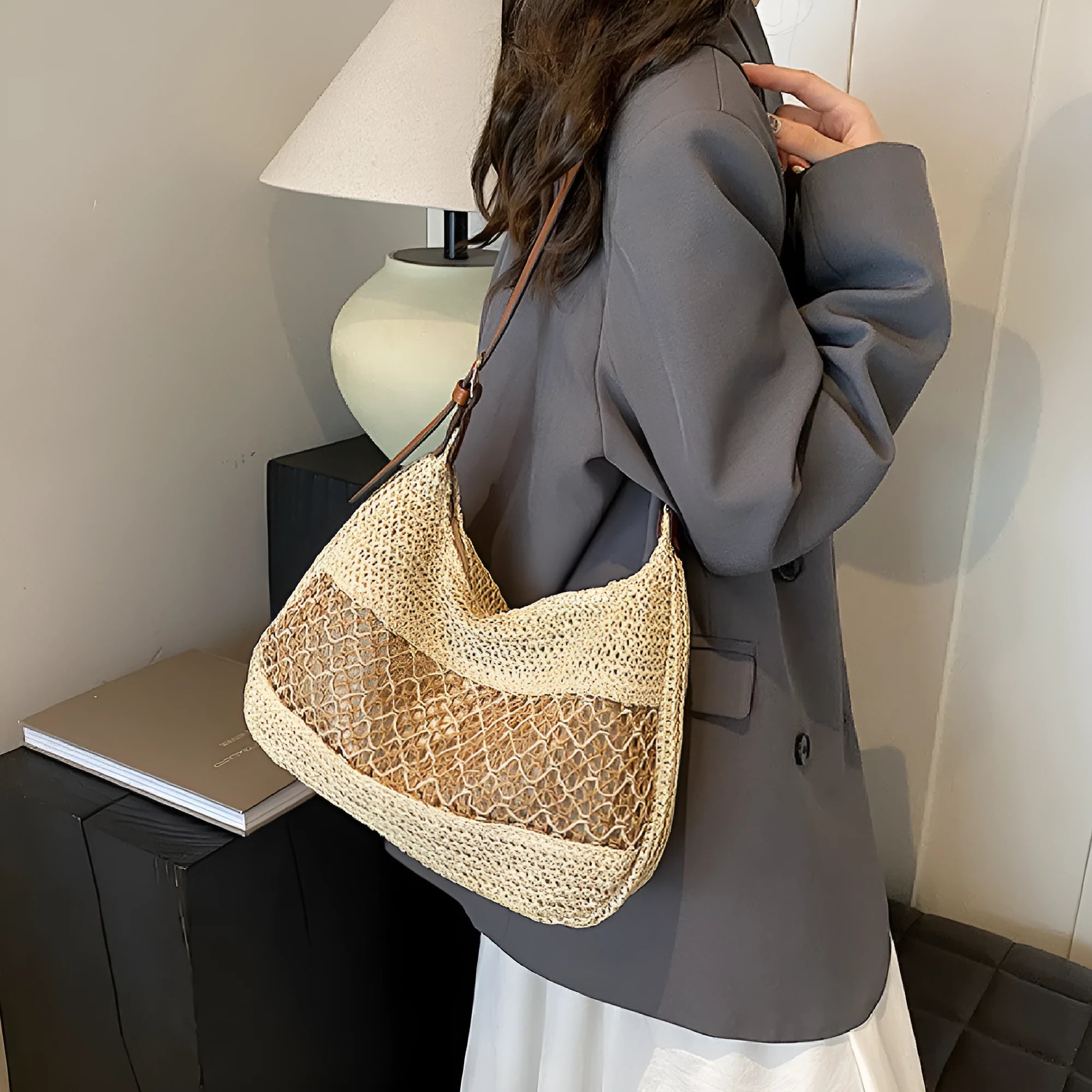 Khaki coloured straw cross body bag with a square shape and an external sandwich pocket.