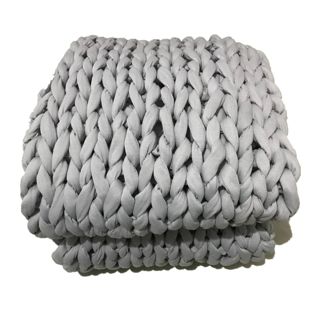 Hand-woven chenille polyester weighted blanket in beige solid colour, 200x200cm size on a bed.