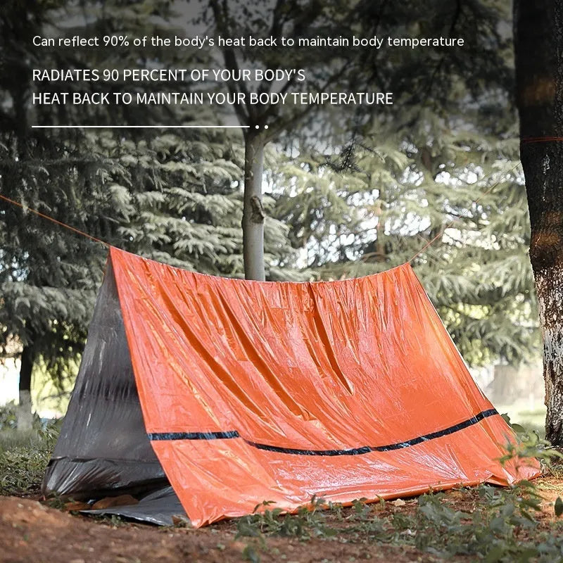 Orange and green emergency tents with sleeping bags and survival whistle for outdoor disaster relief