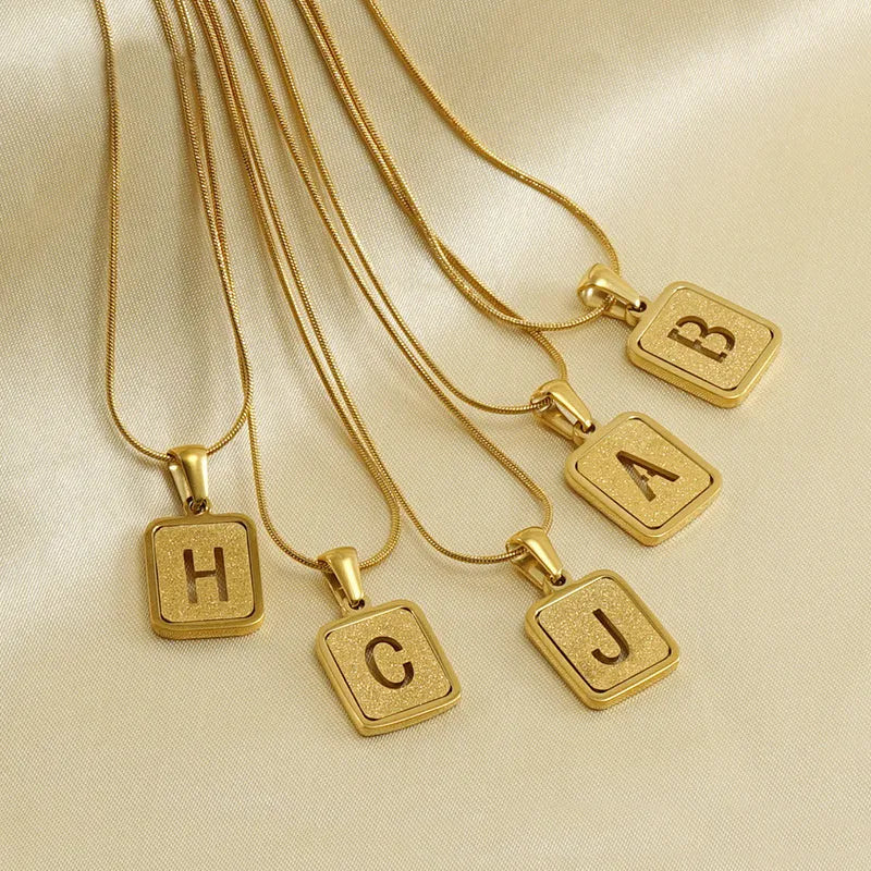 Alphabet necklace with square hollow-out letter pendant in titanium steel, gold or silver electroplated small snake chain