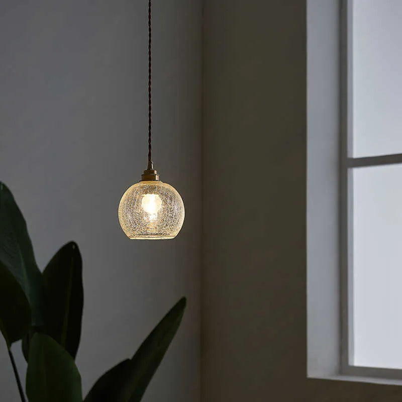 Retro brass ceiling chandelier with a clear glass ball shade, showing copper construction.