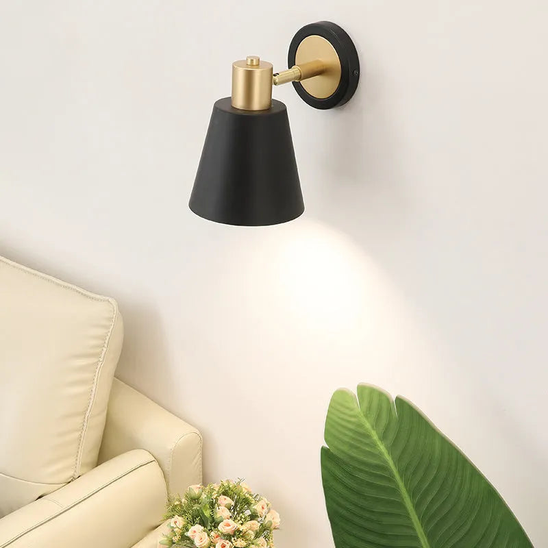 Nordic style iron wall lamp mounted on a wall, showcasing its welded shade design.