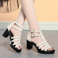 Women's hollow-out high heel sandals with buckle fastening in beige or black colours