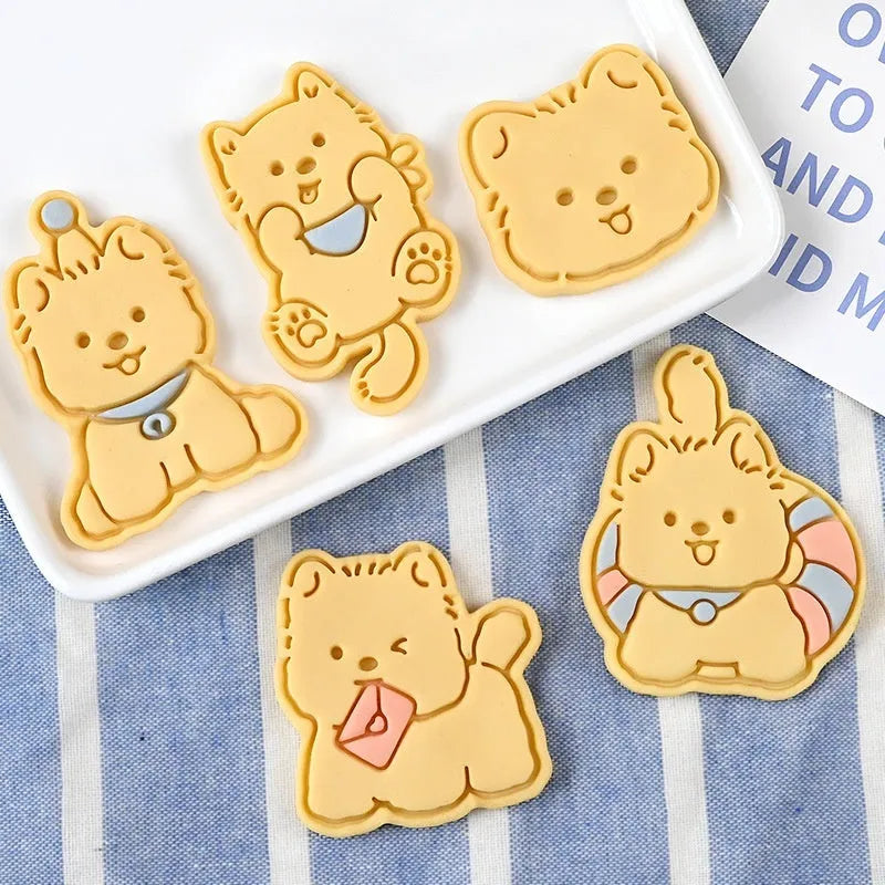 Plastic cartoon biscuit mould showing three-dimensional pet puppy designs including one with a birthday hat