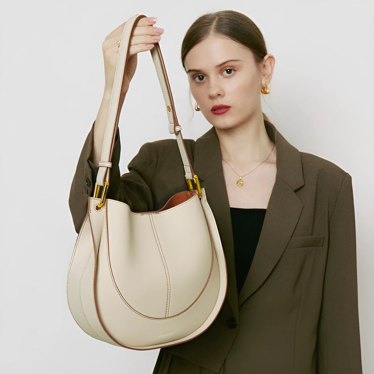Designer small crossbody bag for women, genuine leather, round shape, retro splicing, milkshake white colour