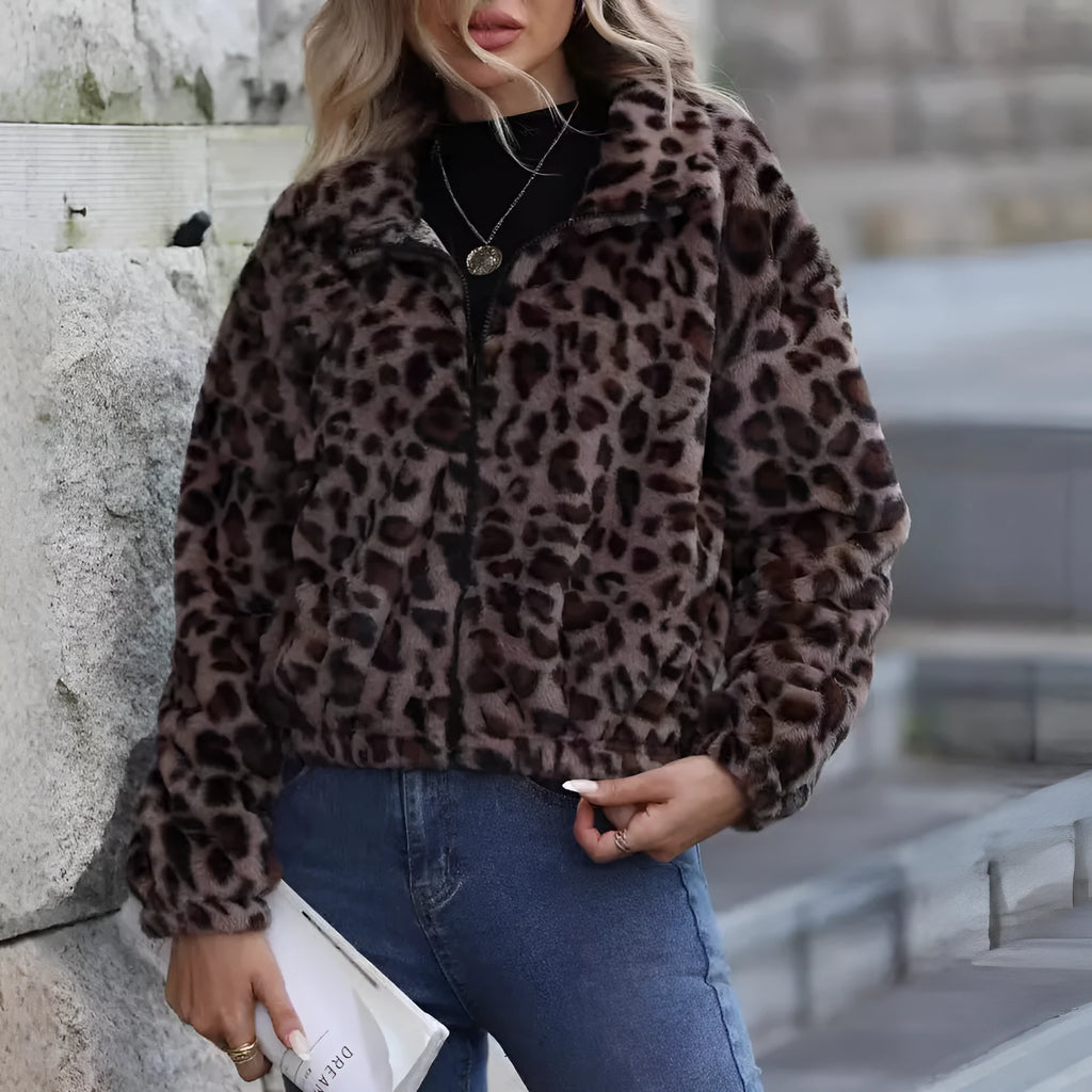 A woman's loose long-sleeve zip-up coat in a plush leopard print fabric with raglan sleeves.