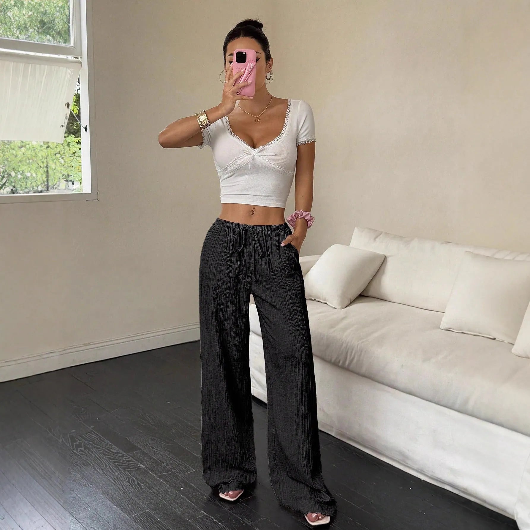 Women's wide-leg black trousers with a lace-up detail on the mid-rise waist
