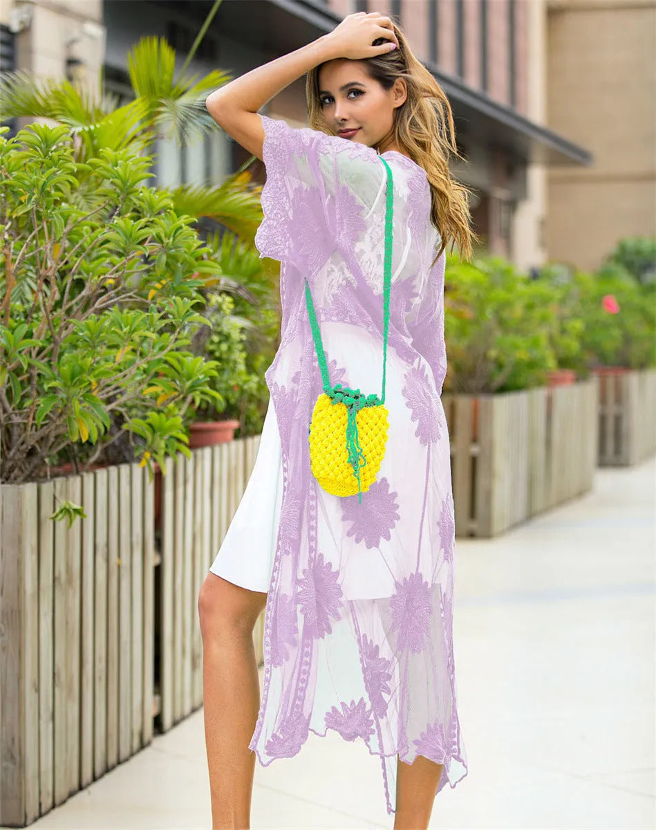 Light purple women's beach dress with lace embroidery, worn as a swimsuit cover-up.