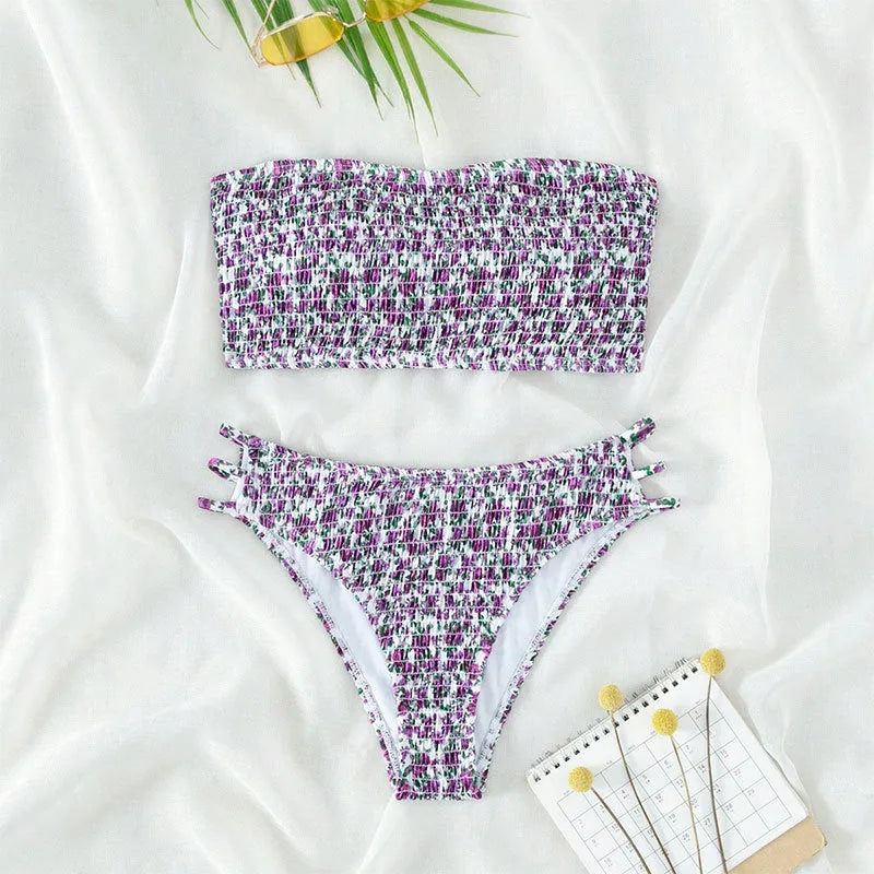Women's floral strapless swimsuit with high-waisted briefs, open back, and split front design on a mannequin.