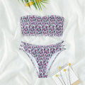 Women's floral strapless swimsuit with high-waisted briefs, open back, and split front design on a mannequin.