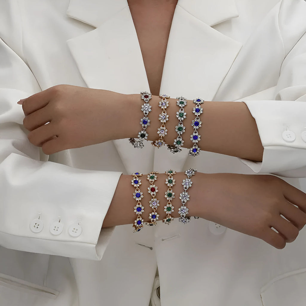 Women's floral charm bracelet in gold or silver electroplate with coloured gemstone effects.