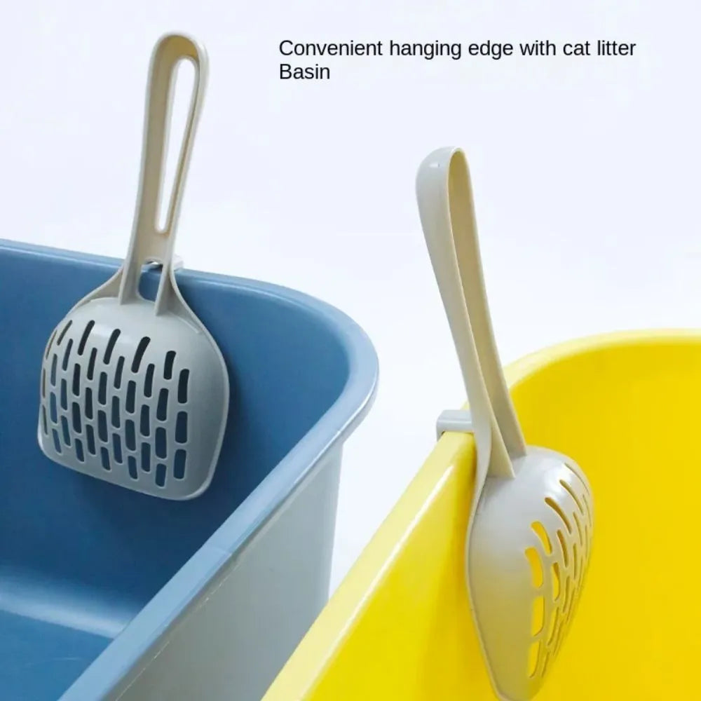 Grey plastic cat litter scoop sitting in its matching base tray